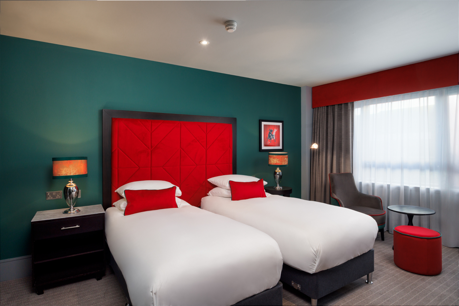 Two beds pushed together with a tartan headboard.