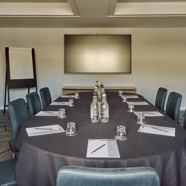 Conference room featuring a spacious table and chairs.