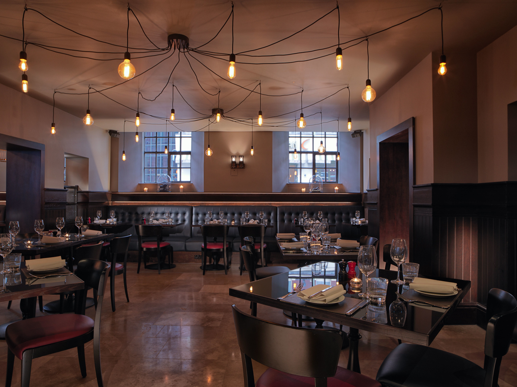 A restaurant featuring numerous tables and chairs.