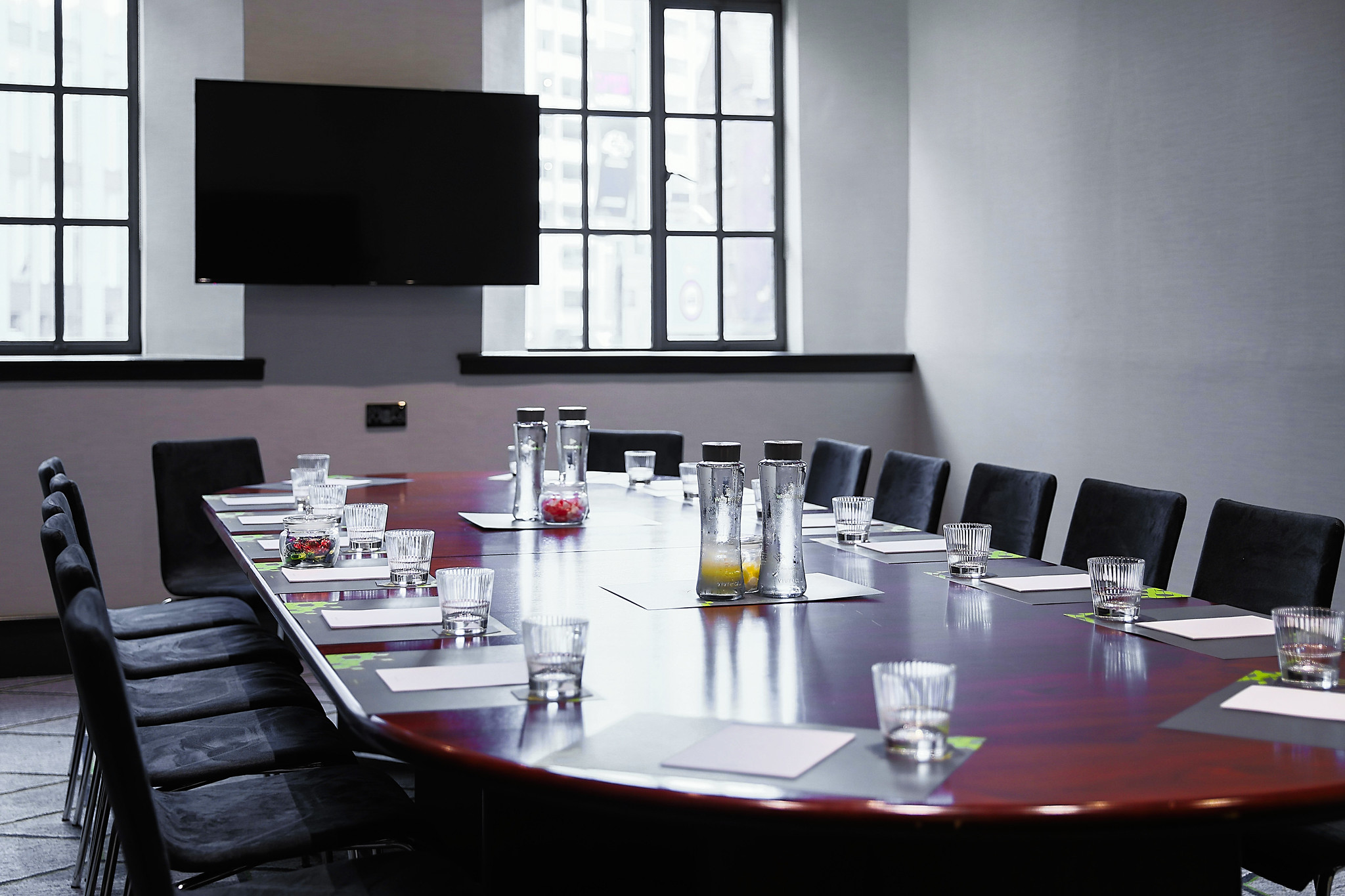 Conference room featuring a spacious table and chairs.